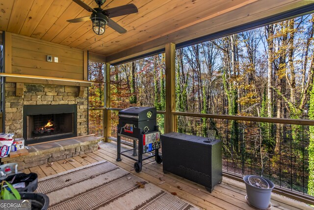 sunroom / solarium with ceiling fan and wood ceiling