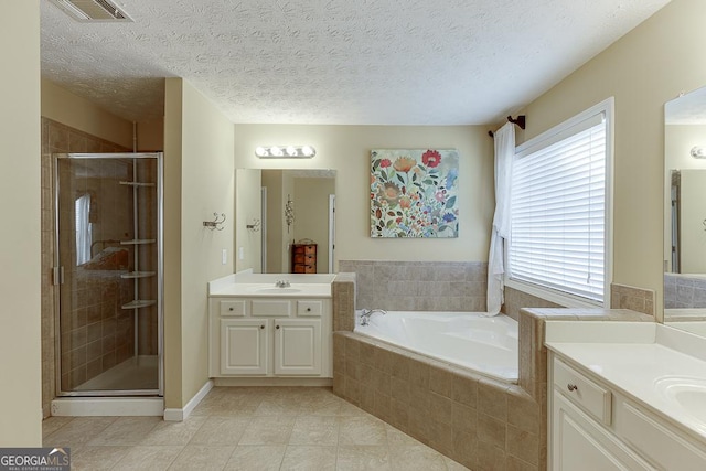 bathroom featuring tile patterned flooring, a textured ceiling, vanity, and shower with separate bathtub