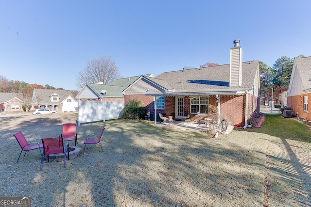 rear view of house featuring a yard and cooling unit