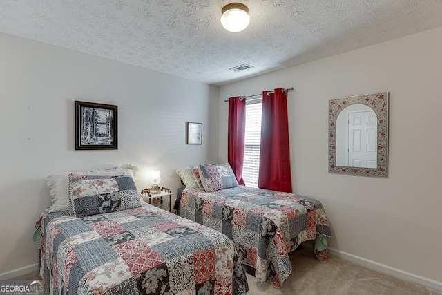 carpeted bedroom featuring a textured ceiling