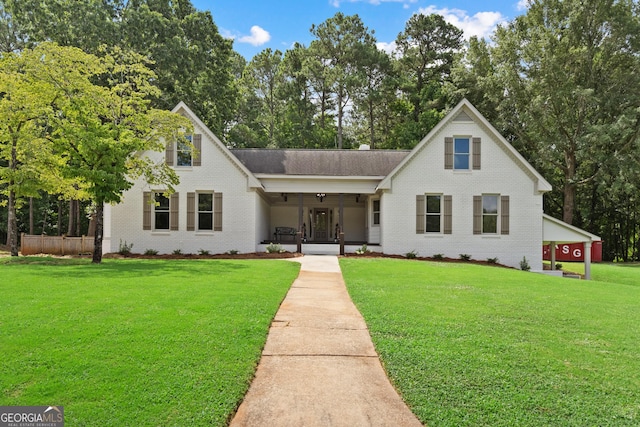 view of front of home with a porch and a front lawn