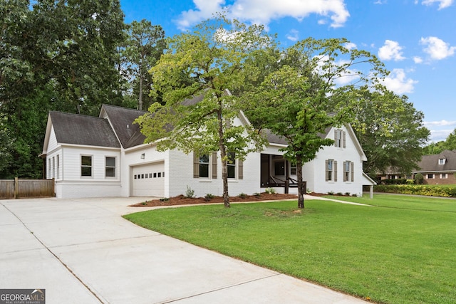 view of front of home featuring a garage and a front lawn