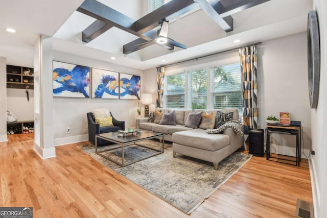 living room featuring ceiling fan, beamed ceiling, and hardwood / wood-style flooring