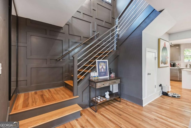 staircase with hardwood / wood-style floors