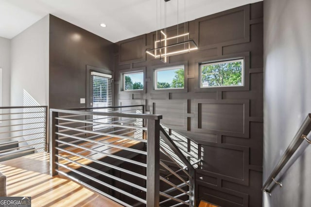 stairway with hardwood / wood-style floors and plenty of natural light