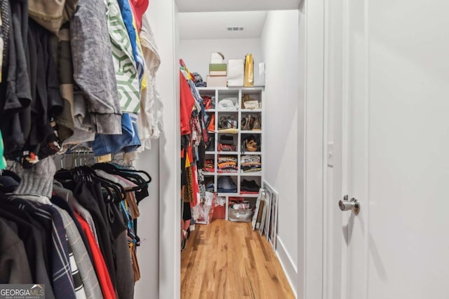 spacious closet featuring light hardwood / wood-style floors