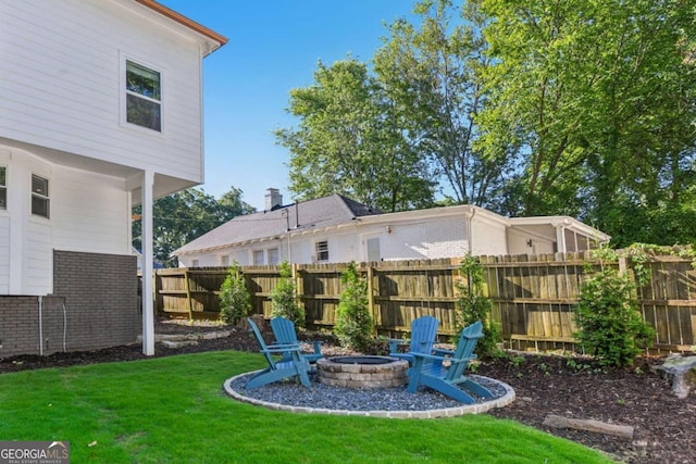 view of yard with a fire pit