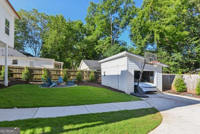 view of yard featuring an outbuilding and a fire pit