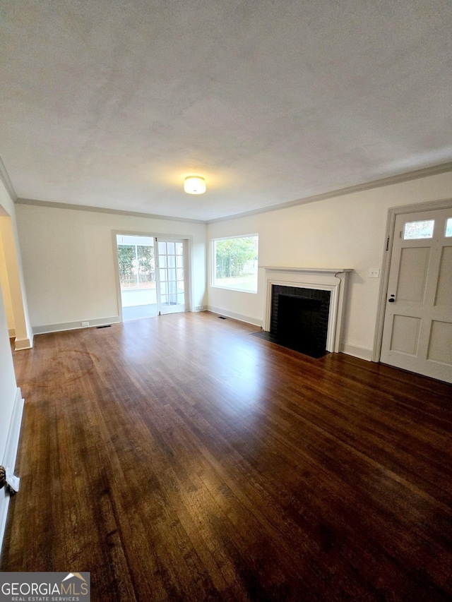 unfurnished living room with a fireplace, a textured ceiling, dark hardwood / wood-style flooring, and crown molding