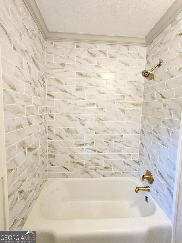 bathroom featuring  shower combination, a textured ceiling, and ornamental molding