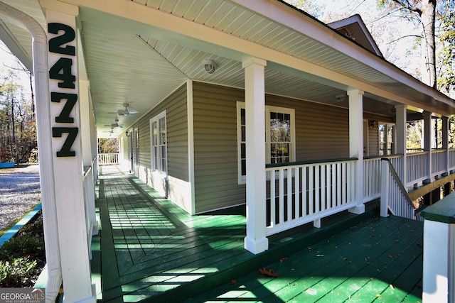 deck with a ceiling fan and a porch