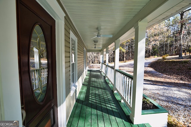 deck with covered porch and a ceiling fan