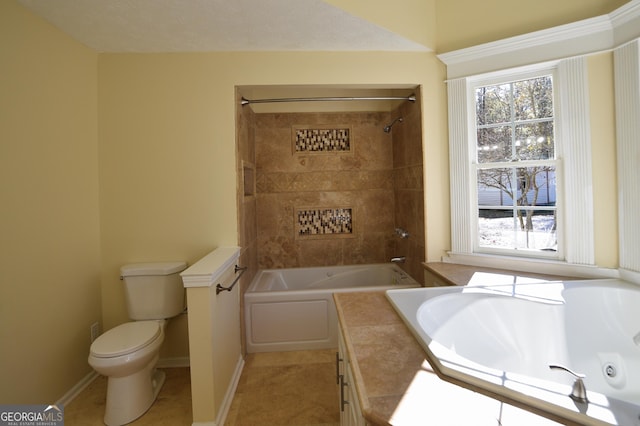 full bathroom with vanity, tiled shower / bath, tile patterned floors, and toilet