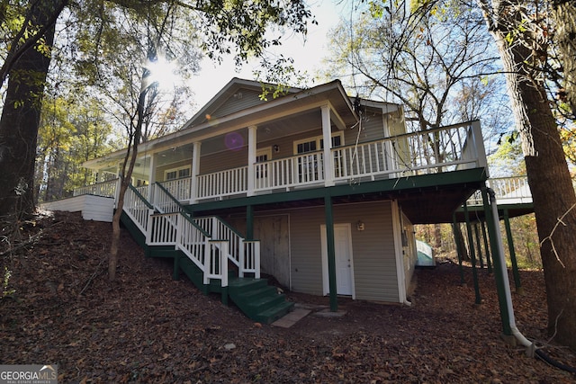 rear view of property featuring stairs
