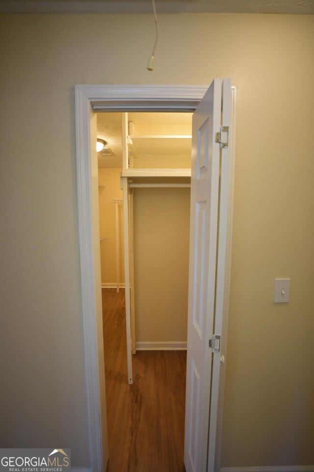 bathroom with vanity, hardwood / wood-style floors, a textured ceiling, and toilet