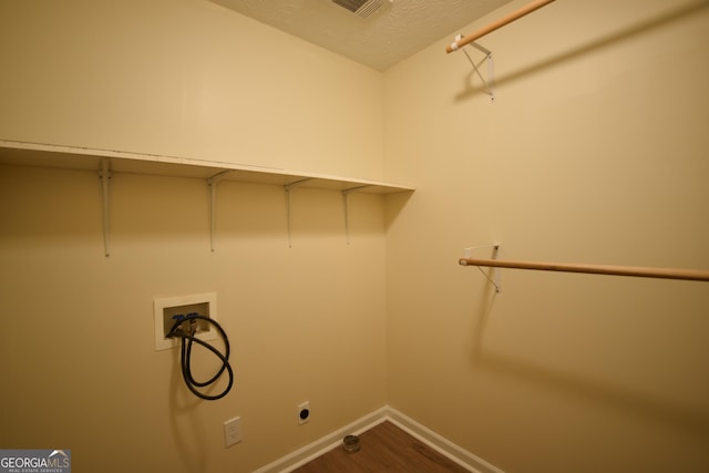 laundry area featuring baseboards, dark wood finished floors, electric dryer hookup, laundry area, and washer hookup