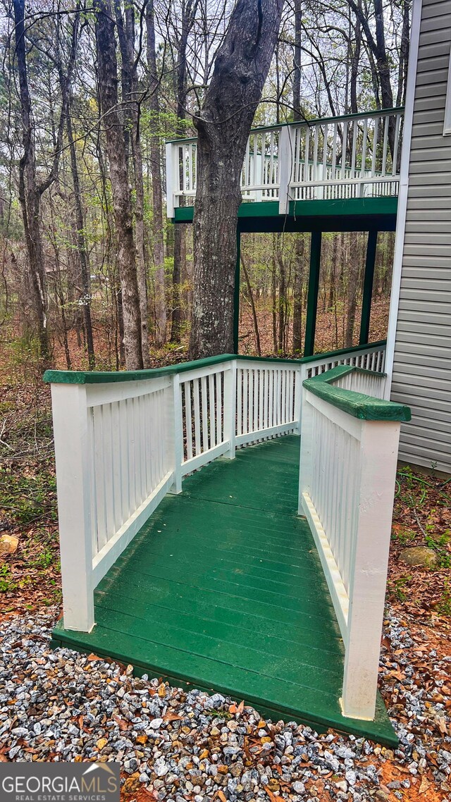 deck with ceiling fan and a porch