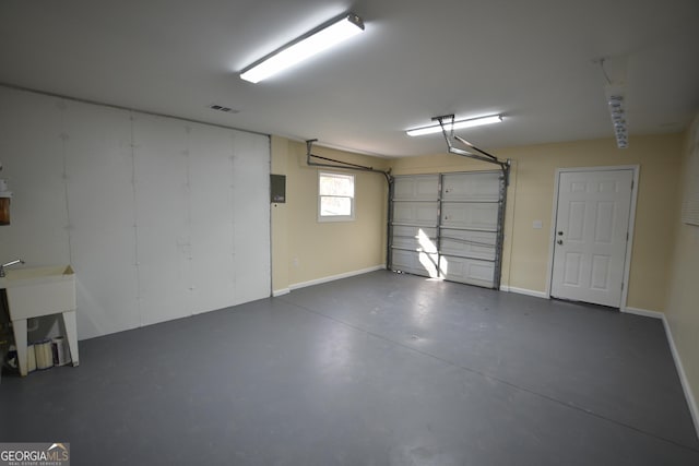 garage featuring baseboards, visible vents, and a sink