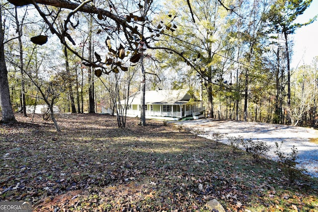 view of yard featuring covered porch