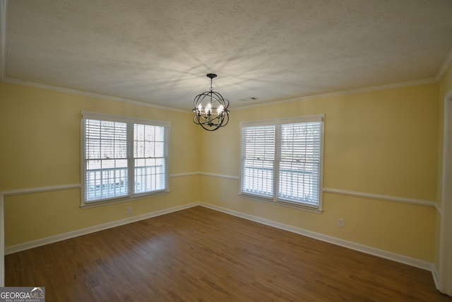 unfurnished room featuring dark wood-type flooring, a healthy amount of sunlight, a chandelier, and a textured ceiling
