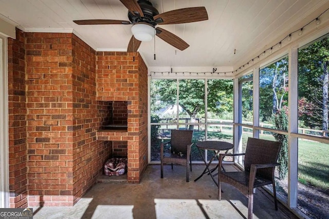 sunroom / solarium with a wealth of natural light and ceiling fan