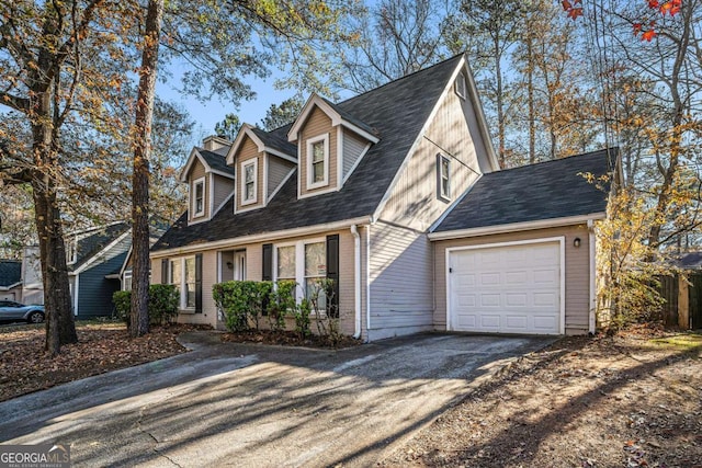 cape cod-style house featuring a garage