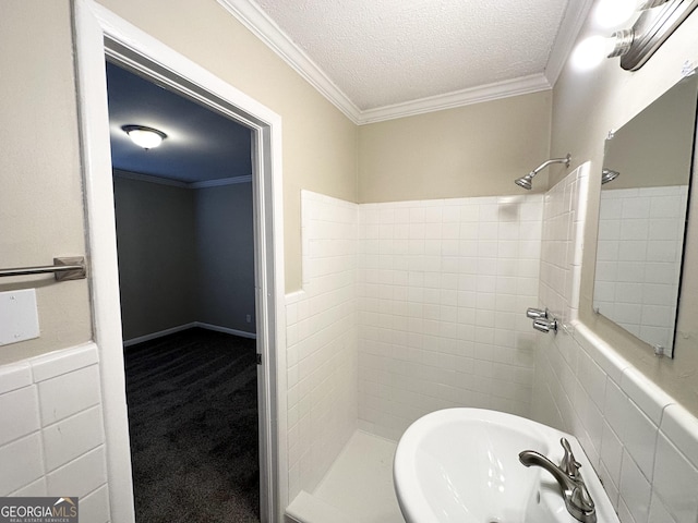 bathroom featuring a tile shower, tile walls, and ornamental molding