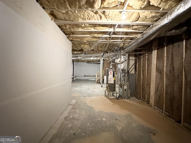 basement featuring heating unit and gas water heater