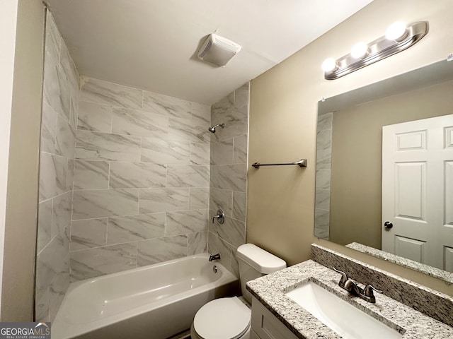 full bathroom featuring vanity, toilet, and tiled shower / bath