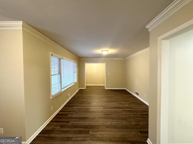 empty room with dark hardwood / wood-style flooring and ornamental molding