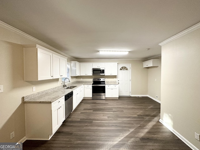 kitchen with ornamental molding, stainless steel appliances, dark wood-type flooring, sink, and white cabinets