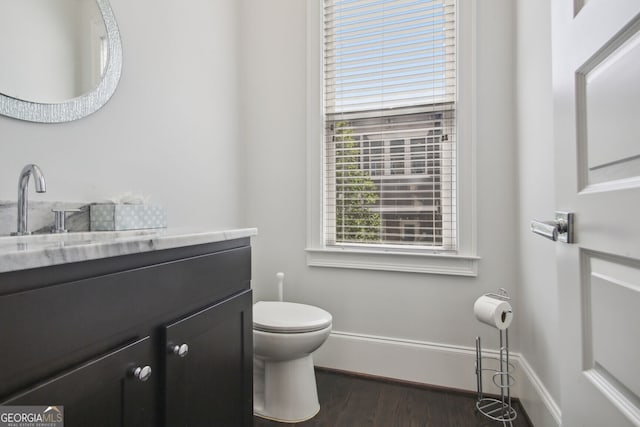 bathroom featuring hardwood / wood-style floors, vanity, and toilet