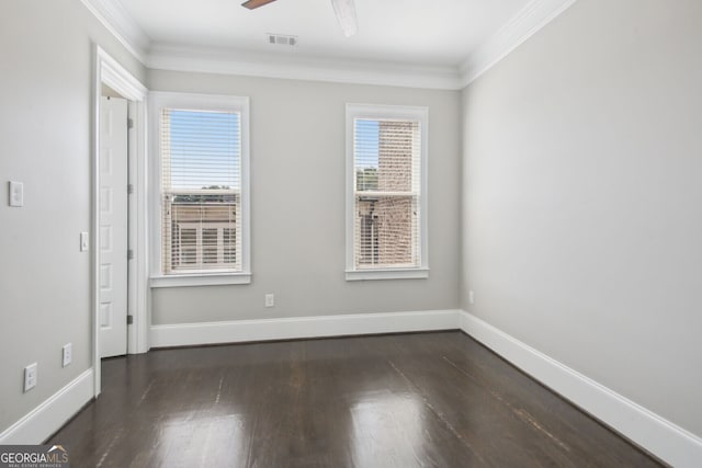 empty room with dark hardwood / wood-style flooring, ceiling fan, plenty of natural light, and ornamental molding