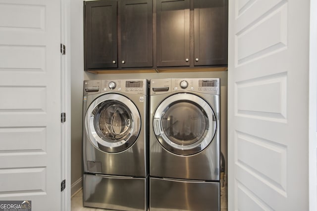 washroom featuring cabinets, independent washer and dryer, and tile patterned floors