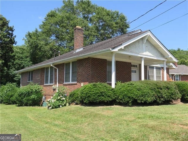 view of side of home with a lawn