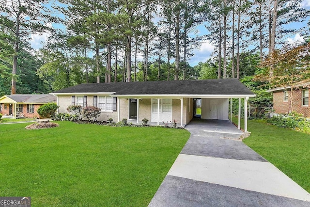 ranch-style home with a carport, covered porch, and a front yard