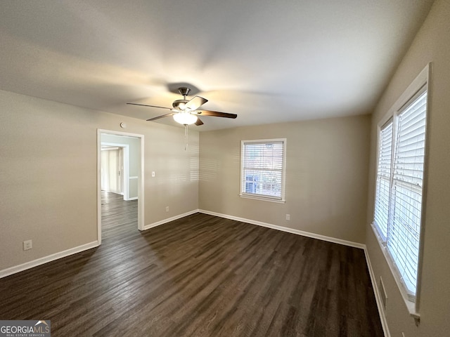 spare room featuring ceiling fan and dark hardwood / wood-style floors