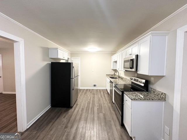 3568 Glenview Cir, Atlanta, GA 30331 - kitchen featuring stainless steel appliances, wood finished floors, white cabinets, light stone counters, and crown molding