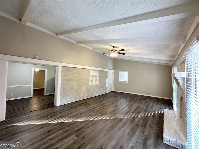 unfurnished living room featuring vaulted ceiling with beams, ceiling fan, dark hardwood / wood-style floors, and a brick fireplace