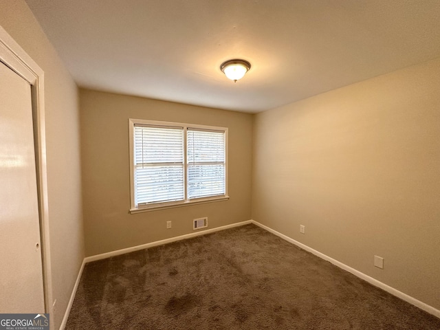 empty room with dark carpet