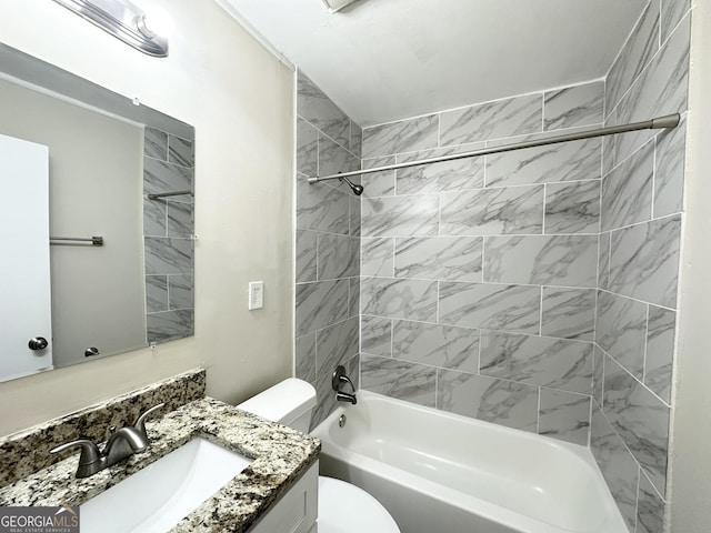 full bathroom with vanity, tiled shower / bath combo, and toilet