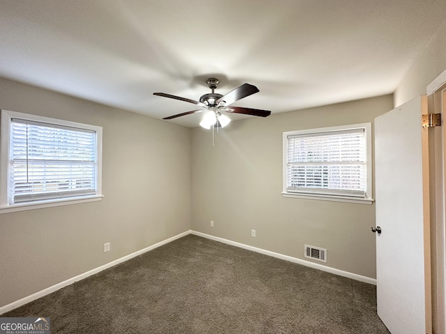 carpeted empty room featuring ceiling fan and a healthy amount of sunlight