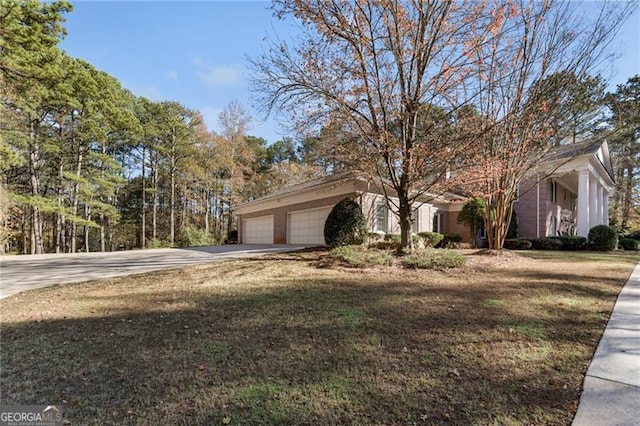 view of front of house with a garage and a front lawn