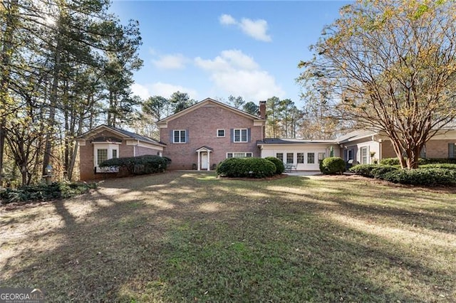 rear view of property featuring a yard