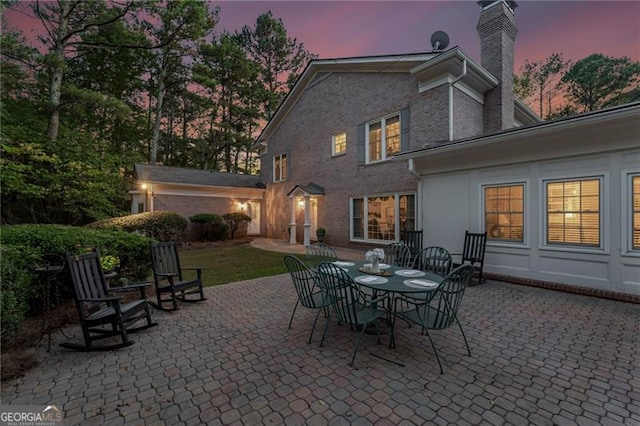 view of patio terrace at dusk