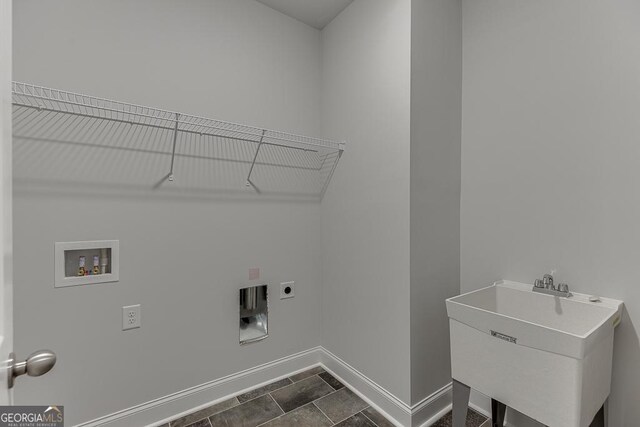 clothes washing area featuring electric dryer hookup, washer hookup, and sink