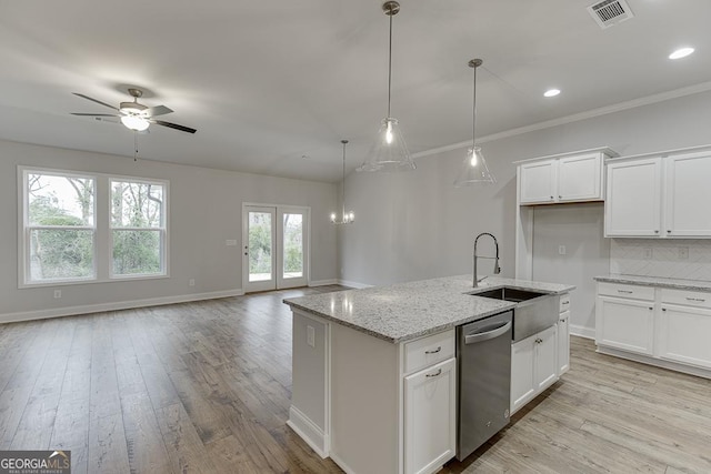 kitchen with white cabinetry, dishwasher, light stone countertops, and a kitchen island with sink