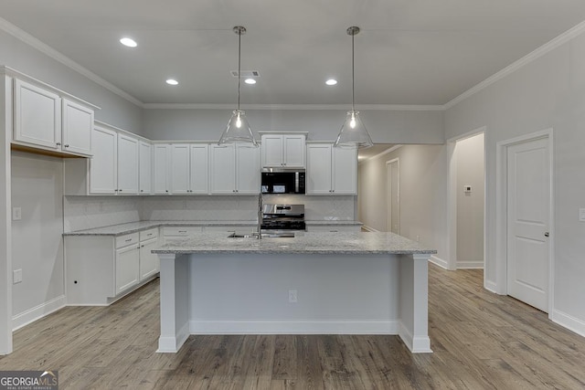 kitchen with pendant lighting, light stone countertops, stainless steel appliances, and white cabinets