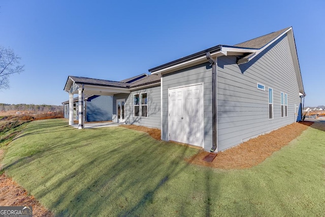 view of side of home with a lawn