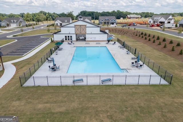 view of pool featuring a lawn and a patio